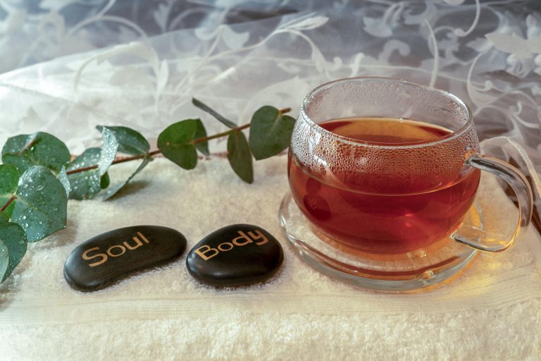 Relaxing scene with herbal tea and stones symbolizing soul and body harmony.